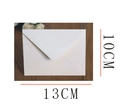Detail view of 13x10cm ivory pearlescent paper envelope with V-flap on wooden background - Small RSVP Envelope