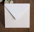 Close-up of pearl-finish ivory square envelope with elegant white rose decor - Flesh Pink Square