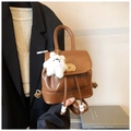 Detail of vintage brown leather backpack with drawstring closure and cute plush bear charm - With Charm / Brown
