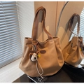Detail of khaki canvas tote bag featuring brown leather straps and cute plush dog charms - With Charm / Brown with Pendant