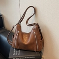 Brown vintage leather tote bag with metallic zipper pockets and stylish tassels - Brown
