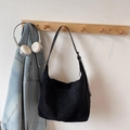 Minimalist black faux suede shoulder tote bag hanging on wooden hook with denim jacket - Black (Without Charm)