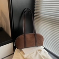 Vintage brown faux suede baguette bag with shoulder strap in a stylish minimal setting - Brown