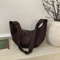 Detailed view of dark brown suede crescent bag with textured stitching and knot detail - Brown
