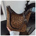 Detail view of leopard print canvas bag with brown leather trim and silver metal buckle - Brown