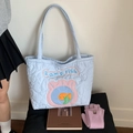 Close-up of light blue quilted tote bag with heart pattern and cute fish embroidery - Blue Fish