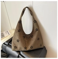 Detailed close-up of brown suede tote bag featuring intricate hollow-out floral patterns - Green