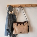 Detail of retro suede crossbody bag with brown leather trim and side pockets on a hook - Camel No Charms