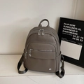Deep grey litchi grain leather backpack with metallic ring zippers and side pockets - Gray