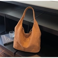 Detail shot of the brown suede tote bag showing its soft matte texture and seamless handle - Brown