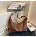Detail van vintage bruine lederen hobo-tas met zachte plooitextuur en verstelbare riem - Bruin