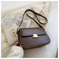 Elegant brown leather crossbody bag with gold square buckle on a chic tweed coat - Brown