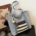 Light blue canvas tote bag with nautical stripes and a decorative plush charm detail - Blue