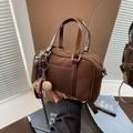 Chic brown suede Boston handbag with smooth leather handles and creative baseball charm - With Charm / Brown