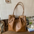 Detail shot of brown minimalist tote bag with pebble texture and drawstring knot - Brown