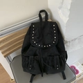 Minimalist black canvas backpack for women featuring silver stud accents and drawstring closure - Black