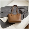 Detail of brown PU leather tote bag with golden fashion lettering on a grey suit jacket - No Pendant / Brown