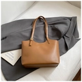 Close-up of brown leather tote bag with gold lettering on a dark grey blazer - No Pendant / Brown