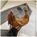 Detail of crescent suede bag featuring pretzel and chocolate charms with rope knot strap - Brown with Pendant