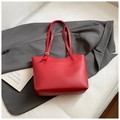 Close-up of red leather tote bag with gold lettering on a stylish grey suit background - No Pendant / Red