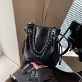Chic black leather bucket bag with silver chain strap and adjustable leather shoulder strap - Black