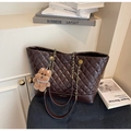 Detail of dark brown quilted tote bag with metal chain strap and a plush bear charm - Coffee with Pendant