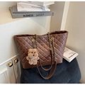 Detailed view of dark brown quilted tote bag with metal chain strap and bear charm - Brown with Pendant