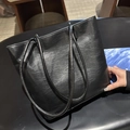 Minimalist black tote bag in glossy textured leather with dual top handles - Black