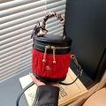 Quilted red velvet bucket bag with black leather trim and silk scarf wrapped handle - Red