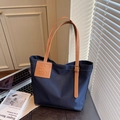 Large capacity navy blue tote bag with brown leather handles and adjustable straps - Blue