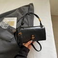 Black textured shoulder bag with a unique knot handle and gold twist lock clasp - Standard Type / Black