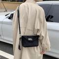 Minimalist black matte crossbody bag with silver twist lock and adjustable strap - Black