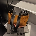 Brown suede handbag with wide black leather strap featuring oversized silver metal eyelets - Brown