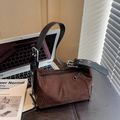 Dark brown faux suede crossbody bag with adjustable wide black strap and silver hardware - Brown