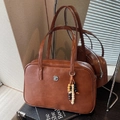 Brown vintage Boston handbag in PU leather with dual handles and beaded tassel charm - Red Brown