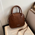 Brown vintage quilted crossbody bag with top handles on book, retro faux leather style - Brown