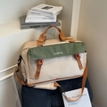 Beige and green travel bag with orange straps on a blue velvet seat for weekend trips - Khaki