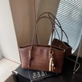 Brown woven texture tote bag with shoulder straps and beaded charm accessory - Brown