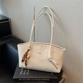 Minimalist creamy white woven tote bag with wooden bead charm and long shoulder straps - Off White