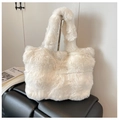 Detailed close-up of large white plush faux fur tote bag with soft shoulder strap handle - White