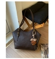 Detail of dark brown vintage tote bag with adjustable straps and a plush bear pendant - With Pendant / Coffee