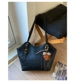 Detail of black tote bag featuring retro leather texture and cute brown plush bear charm - With Pendant / Black