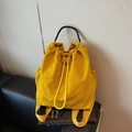 Bright yellow drawstring backpack in stylish nylon with black braided handle accents - Yellow