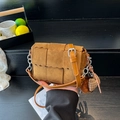 Brown woven suede crossbody bag with wavy edge detail and decorative plush pendant - Brown with Pendant