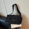 Minimalist black nylon crossbody tote bag with adjustable shoulder strap and brand logo - Black