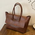 Brown leather tote bag in minimalist style featuring unique overlap flap and dual handles - Brown