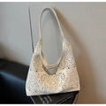 Detailed macro of white laser-cut hollow pattern on luxury tote bag with soft lighting - Off White