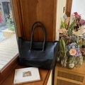 Large black leather tote bag with flap closure and slim handles for commuting women - Black