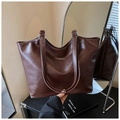 Close-up of vintage large capacity dark brown tote bag with leather texture and white lettering - Brown