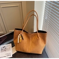 Detail of tan suede tote bag with decorative bead tassel on dark desk background - Brown with Pendant